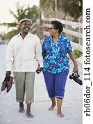 Senior African American couple walking on boardwalk