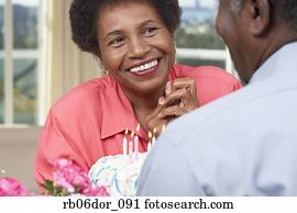 Senior African American couple with birthday cake