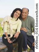 Senior couple hugging and smiling outdoors