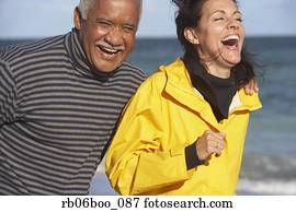Senior couple laughing at beach Senior couple laughing at beach