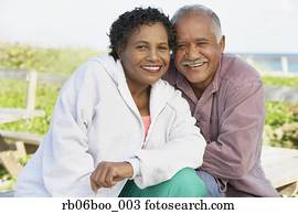 Senior couple smiling and hugging outdoors