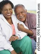 Senior couple smiling and hugging outdoors