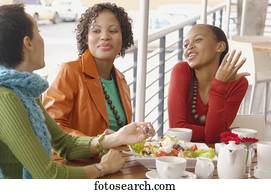 Three women eating and talking 