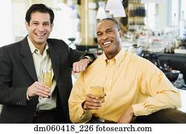 Two men with drinks at bar