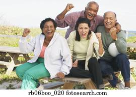 Two senior couples cheering outdoors