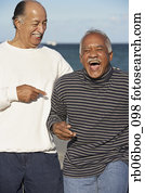 Two senior men laughing outdoors