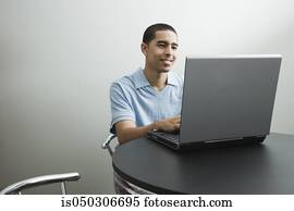 Young African man using laptop