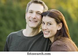 Couple hugging and smiling outdoors Couple hugging and smiling outdoors