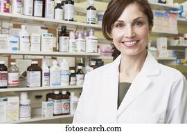 Female pharmacist smiling in pharmacy