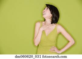 Studio shot of Asian woman looking up and laughing