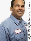Studio shot of Hispanic maintenance man smiling