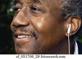 Close up of senior African man with earbud