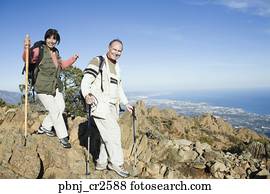 Senior couple hiking on cliffs Senior couple hiking on cliffs