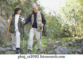 Senior couple hiking with poles