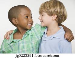 Two young boys smiling at each other