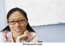 Portrait of Asian businesswoman in front of whiteboard