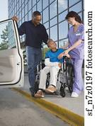 African boy in wheelchair leaving hospital with father