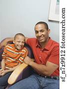 African father and son in waiting room