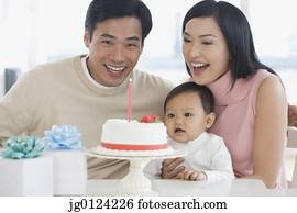 Asian family celebrating baby's first birthday