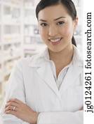Asian female pharmacist standing in pharmacy