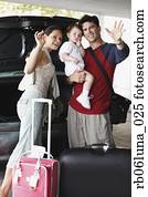 Hispanic family going on trip and waving