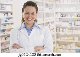 Hispanic female pharmacist smiling in pharmacy