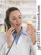 Hispanic female pharmacist talking on telephone