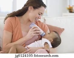 Hispanic mother bottle feeding baby