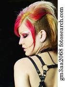 Rear view of young Hispanic woman with punk hair and clothing