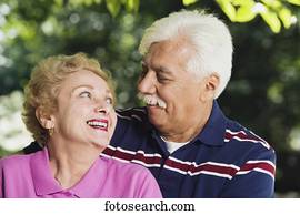 Senior Hispanic couple smiling at each other