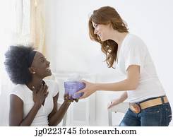 Two women exchanging gifts