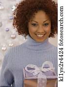 African woman holding Christmas gift