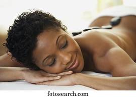 African woman receiving spa treatment