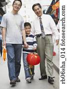Asian grandfather, father and son walking on sidewalk