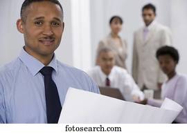 Indian businessman with co-workers in background