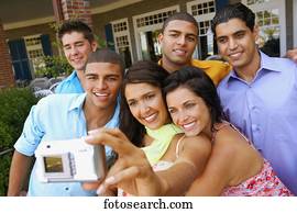Multi-ethnic friends taking own photograph