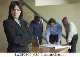 Portrait of businesswoman with coworkers in background