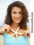 Woman holding up starfish