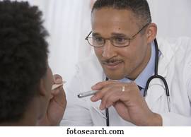 African doctor examining patient