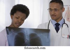 African male doctor and patient looking at x-ray
