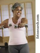 African woman exercising with weights