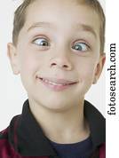 Close up of boy crossing eyes