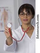 Female doctor holding up stethoscope