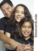 Hispanic family hugging