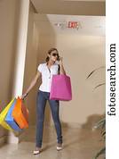 Hispanic woman carrying shopping bags