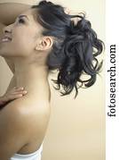 Hispanic woman holding up hair
