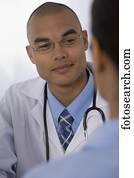 Male doctor listening to patient
