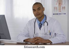 Male doctor sitting at desk
