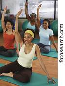 Multi-ethnic women in yoga class