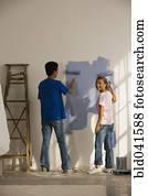 Asian couple painting interior house
